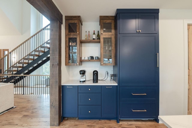 W329N6597 Forest Dr, Hartland, WI 53029 - indoor wet bar featuring light wood-type flooring and stairs