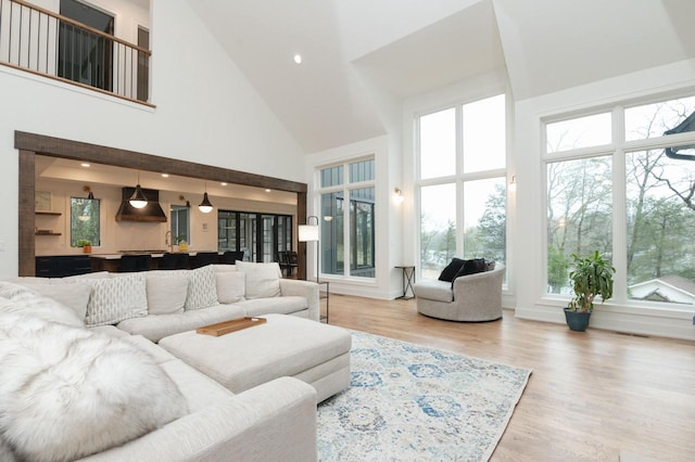 W329N6597 Forest Dr, Hartland, WI 53029 - living area featuring a high ceiling, plenty of natural light, wood finished floors, and recessed lighting