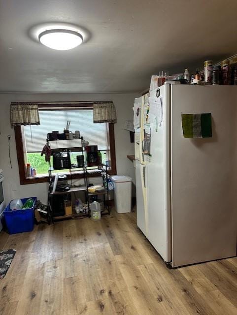 218 Meade Ave, Black River Falls, WI 54615 - kitchen with freestanding refrigerator, light wood-type flooring, and healthy amount of natural light