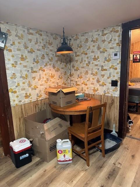 218 Meade Ave, Black River Falls, WI 54615 - dining space with wallpapered walls, wood finished floors, wainscoting, and wood walls