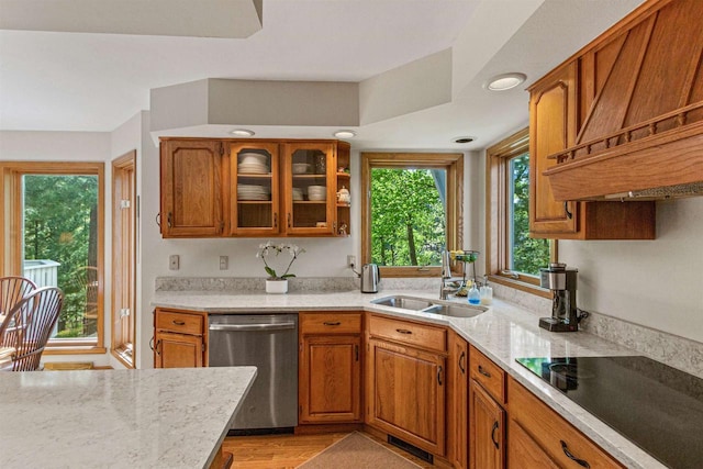 N1124 County Rd E, Waupaca, WI 54981 - kitchen with stainless steel dishwasher, custom range hood, black electric cooktop, a sink, and brown cabinets