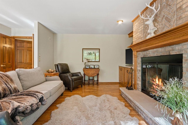 N1124 County Rd E, Waupaca, WI 54981 - living area featuring a fireplace, light wood-type flooring, and baseboards