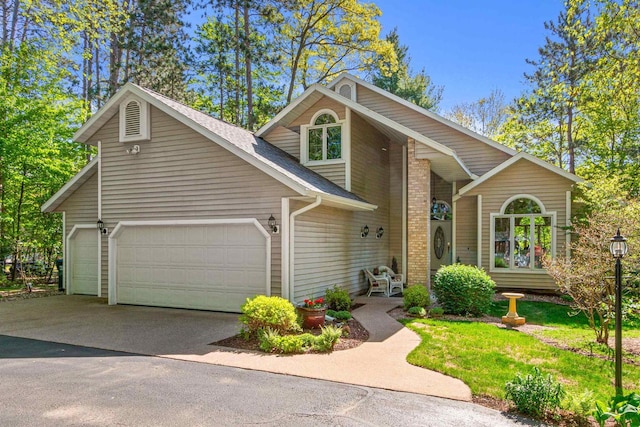 N1124 County Rd E, Waupaca, WI 54981 - view of front of property featuring an attached garage and asphalt driveway