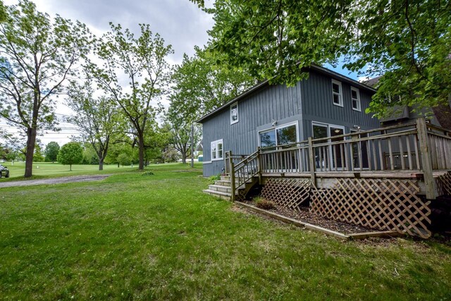 3218 Aalseth Ln, Stoughton, WI 53589 - view of home's exterior with a lawn and a deck