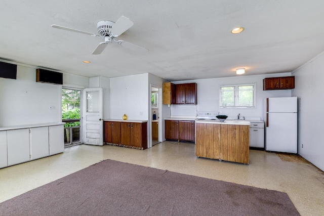 3218 Aalseth Ln, Stoughton, WI 53589 - kitchen featuring freestanding refrigerator, healthy amount of natural light, light countertops, a kitchen island, and recessed lighting