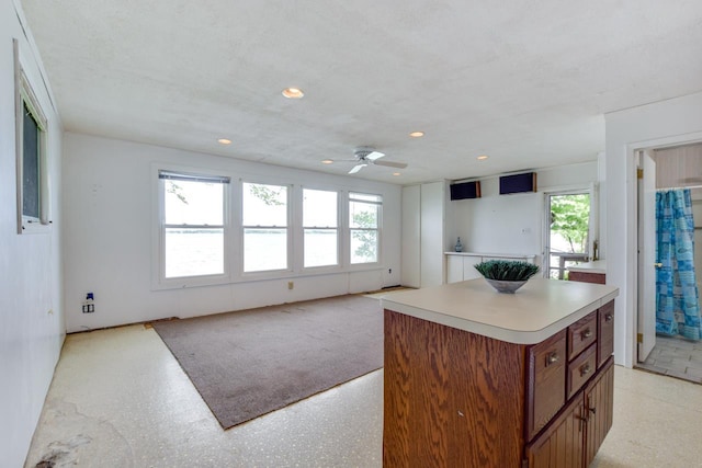 3218 Aalseth Ln, Stoughton, WI 53589 - kitchen featuring healthy amount of natural light, brown cabinetry, a center island, a ceiling fan, and recessed lighting