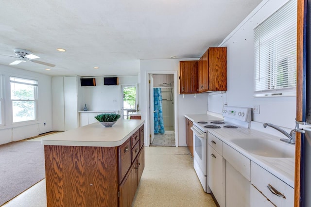 3218 Aalseth Ln, Stoughton, WI 53589 - kitchen with white electric range oven, a sink, brown cabinetry, light countertops, and recessed lighting