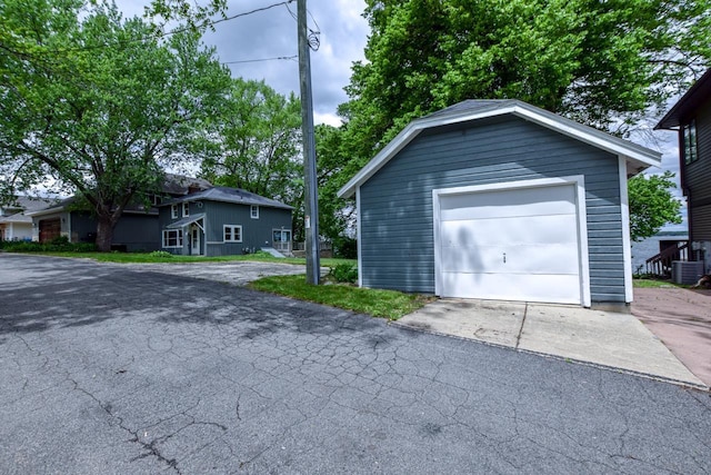 3218 Aalseth Ln, Stoughton, WI 53589 - detached garage featuring central air condition unit and asphalt driveway