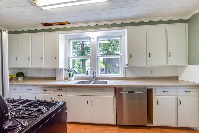 3218 Aalseth Ln, Stoughton, WI 53589 - kitchen featuring dishwasher, a sink, black gas range oven, and white cabinets