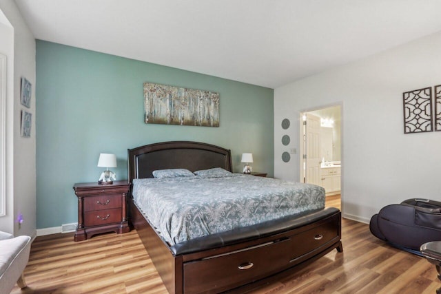 14048 W Waters Edge Trl, New Berlin, WI 53151 - bedroom with wood finished floors, baseboards, and ensuite bath