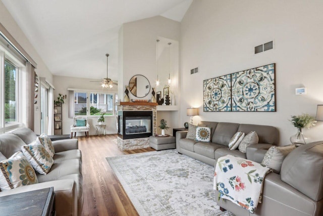 14048 W Waters Edge Trl, New Berlin, WI 53151 - living room with wood finished floors, ceiling fan, high vaulted ceiling, and a stone fireplace