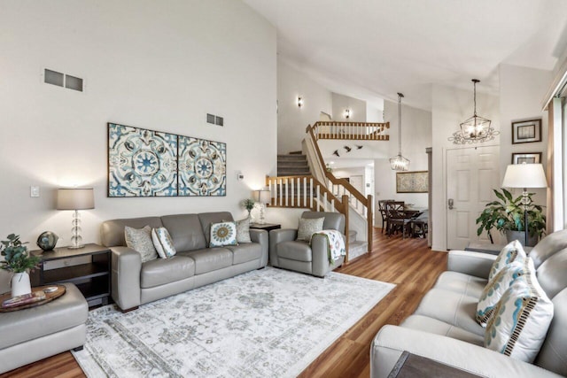 14048 W Waters Edge Trl, New Berlin, WI 53151 - living area featuring stairway, a chandelier, wood finished floors, and high vaulted ceiling