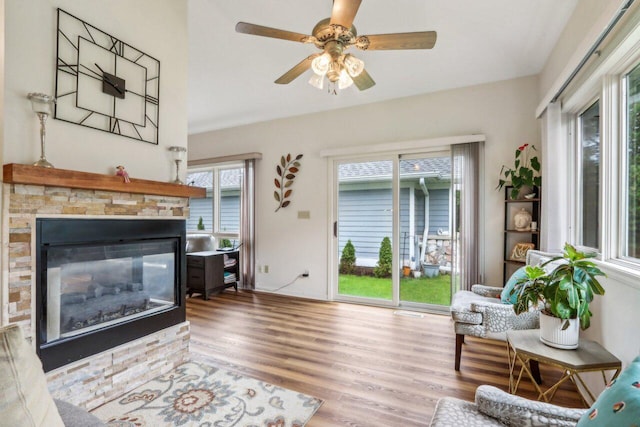 14048 W Waters Edge Trl, New Berlin, WI 53151 - living area featuring wood finished floors, a ceiling fan, and a stone fireplace
