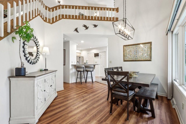 14048 W Waters Edge Trl, New Berlin, WI 53151 - dining space with wood finished floors, baseboards, a high ceiling, healthy amount of natural light, and recessed lighting