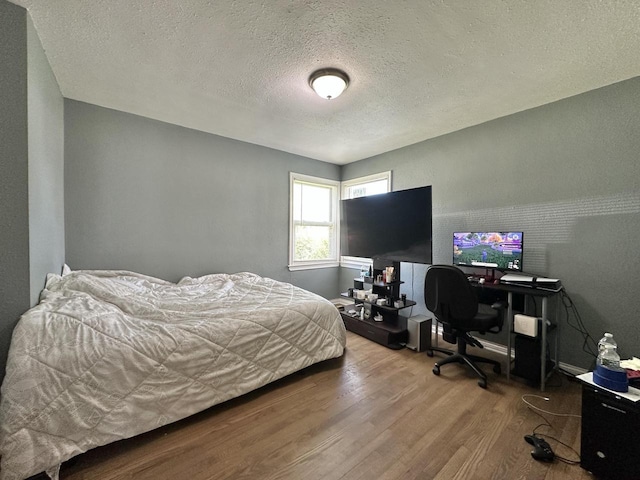 5936 N 35th St, Milwaukee, WI 53209 - bedroom with wood finished floors, a textured ceiling, and a desk