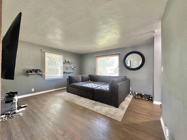 5936 N 35th St, Milwaukee, WI 53209 - living room featuring wood finished floors, a textured ceiling, baseboards, and a textured wall