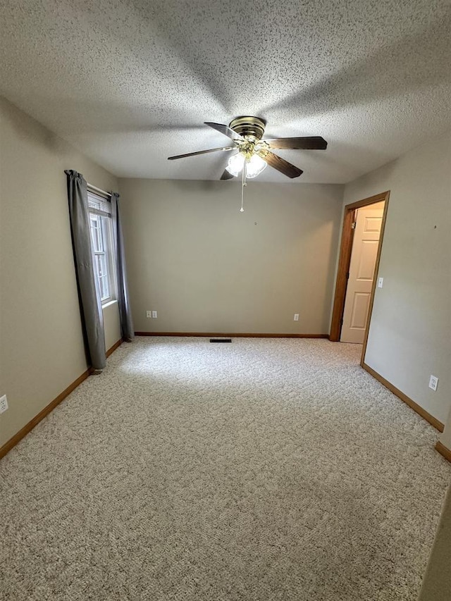 433 Eberlein Ct, Mauston, WI 53948 - unfurnished room featuring light colored carpet, a ceiling fan, baseboards, and a textured ceiling