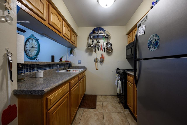 8525 W Waterford Ave Unit 1, Greenfield, WI 53228 - kitchen featuring black appliances, a sink, brown cabinets, and dark countertops