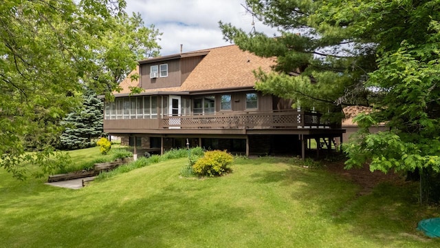 10029 W Spring Rd, Fox Lake, WI 53933 - rear view of property featuring a sunroom, a wooden deck, a lawn, and a shingled roof