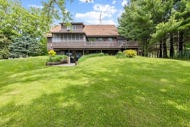 10029 W Spring Rd, Fox Lake, WI 53933 - back of house with a sunroom, a yard, and a deck
