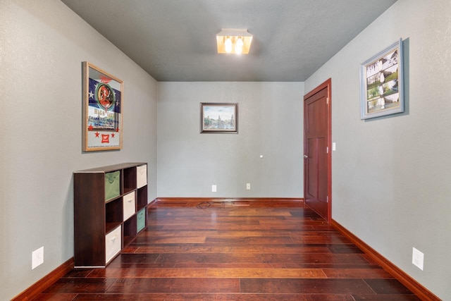 10029 W Spring Rd, Fox Lake, WI 53933 - unfurnished room featuring dark wood-style floors and baseboards