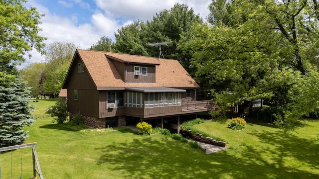 10029 W Spring Rd, Fox Lake, WI 53933 - back of property with a sunroom, a yard, roof with shingles, and a wooden deck