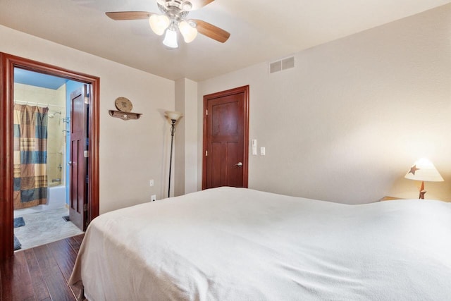 10029 W Spring Rd, Fox Lake, WI 53933 - bedroom featuring dark wood-style floors, ceiling fan, and connected bathroom