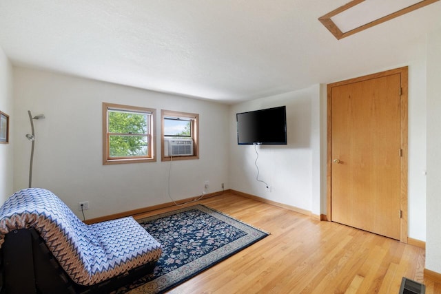 10029 W Spring Rd, Fox Lake, WI 53933 - living area with light wood-style floors, baseboards, and cooling unit