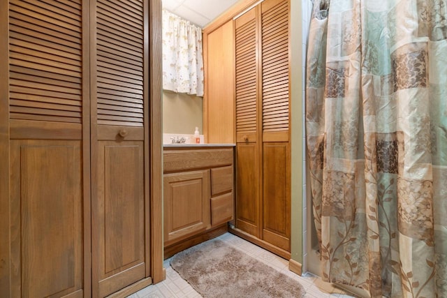 10029 W Spring Rd, Fox Lake, WI 53933 - bathroom featuring a closet, tile patterned flooring, vanity, and a shower with curtain