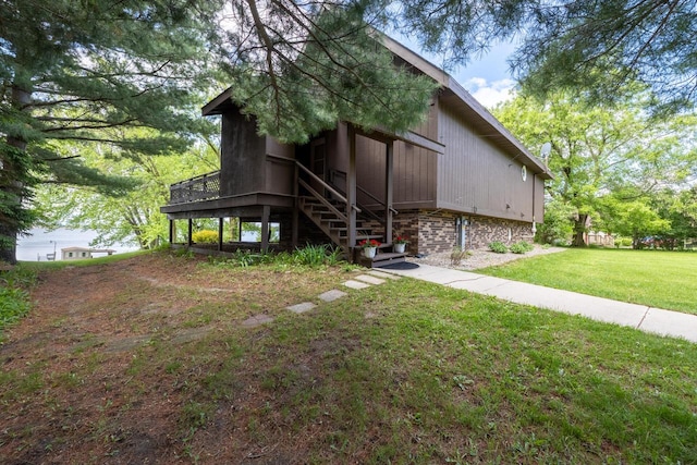 10029 W Spring Rd, Fox Lake, WI 53933 - rear view of house featuring stairway and a lawn