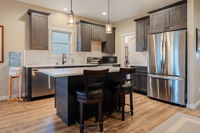 W4936 Battlestone Station Rd, La Crosse, WI 54601 - kitchen featuring stainless steel appliances, a sink, decorative backsplash, light countertops, and recessed lighting