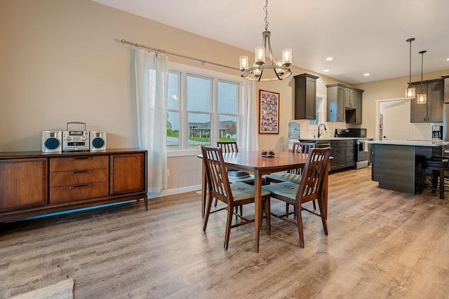 W4936 Battlestone Station Rd, La Crosse, WI 54601 - dining area featuring a chandelier, light wood finished floors, baseboards, and recessed lighting
