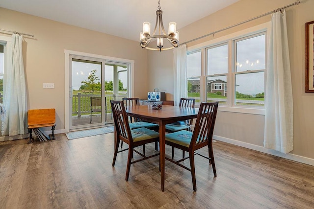 W4936 Battlestone Station Rd, La Crosse, WI 54601 - dining space featuring a chandelier, wood finished floors, and baseboards