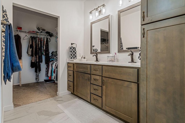 W4936 Battlestone Station Rd, La Crosse, WI 54601 - full bathroom featuring double vanity, marble finish floors, a spacious closet, and baseboards