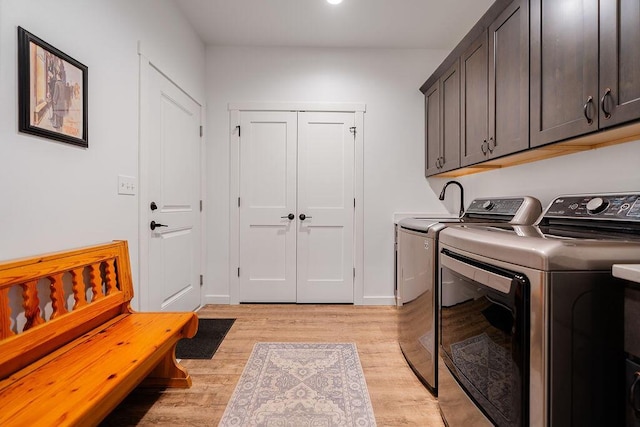 W4936 Battlestone Station Rd, La Crosse, WI 54601 - washroom with cabinet space, washing machine and dryer, light wood finished floors, and recessed lighting
