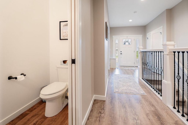W4936 Battlestone Station Rd, La Crosse, WI 54601 - hall with wood finished floors, baseboards, recessed lighting, and an upstairs landing