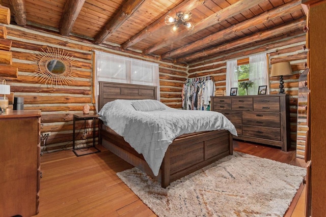 W3276 Princeton Rd, Green Lake, WI 54941 - bedroom featuring wooden ceiling with exposed beams, log walls, and hardwood / wood-style flooring