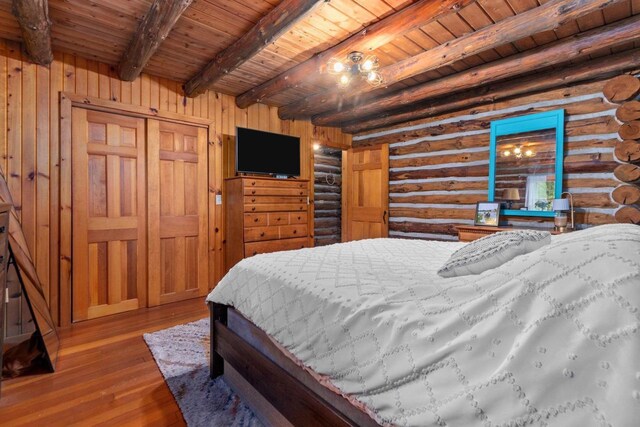 W3276 Princeton Rd, Green Lake, WI 54941 - bedroom with wood ceiling with exposed beams, log walls, and hardwood / wood-style floors