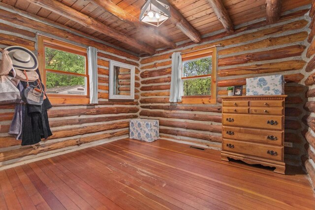 W3276 Princeton Rd, Green Lake, WI 54941 - spare room with wood ceiling with exposed beams, wood-type flooring, and log walls