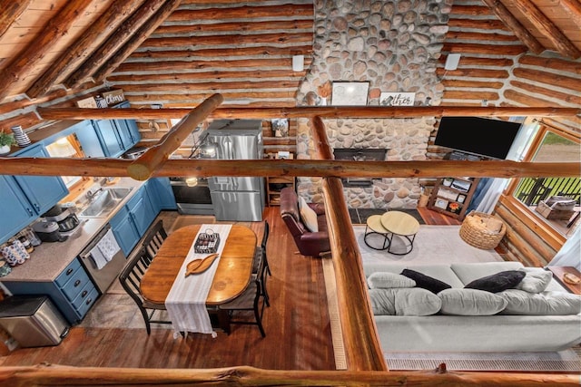 W3276 Princeton Rd, Green Lake, WI 54941 - living area featuring rustic walls, wood finished floors, and beam ceiling
