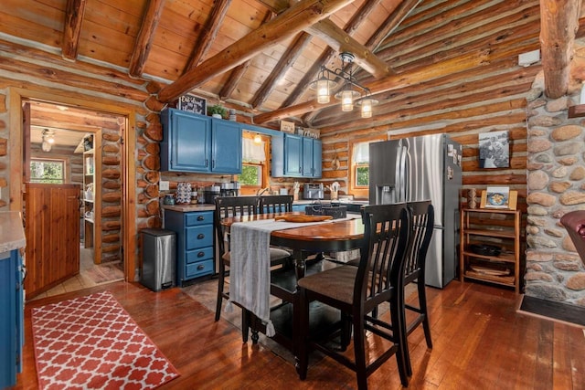 W3276 Princeton Rd, Green Lake, WI 54941 - kitchen with blue cabinetry, stainless steel fridge, dark wood finished floors, wooden ceiling, and rustic walls