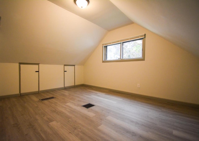 4407 N 57th St, Milwaukee, WI 53218 - bonus room featuring wood finished floors, baseboards, and lofted ceiling