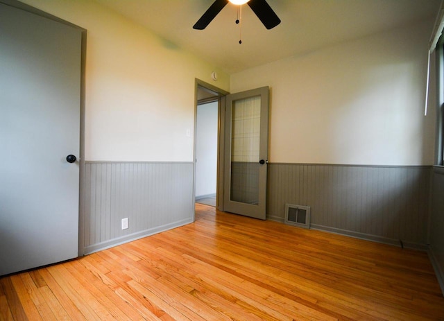 4407 N 57th St, Milwaukee, WI 53218 - empty room featuring wainscoting, hardwood / wood-style floors, and ceiling fan