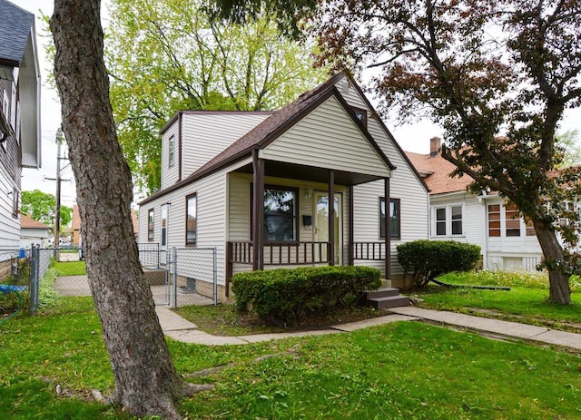 4407 N 57th St, Milwaukee, WI 53218 - view of front of property with covered porch, a gate, and roof with shingles
