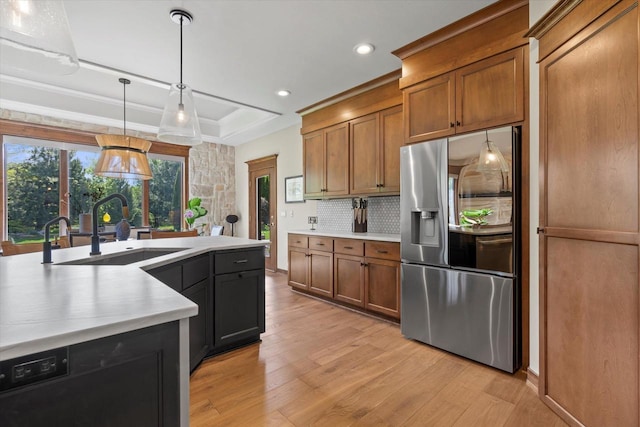 4021 Three Penny Ct, De Pere, WI 54115 - kitchen with stainless steel refrigerator with ice dispenser, a sink, a tray ceiling, light wood-style flooring, and light countertops