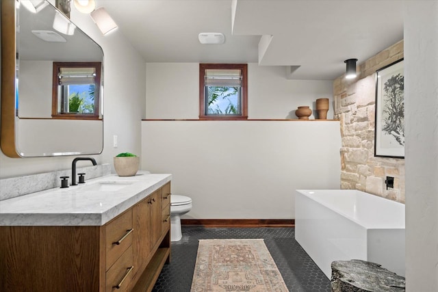 4021 Three Penny Ct, De Pere, WI 54115 - bathroom featuring a freestanding tub, vanity, toilet, and baseboards