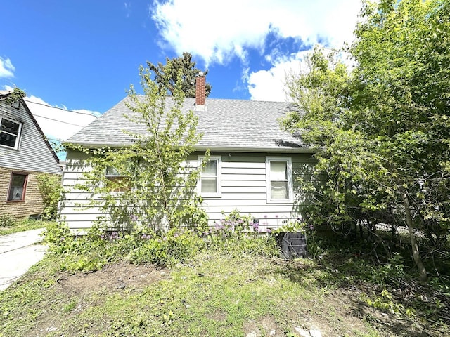 5501 W Thurston Ave, Milwaukee, WI 53218 - view of front of house featuring a chimney and roof with shingles