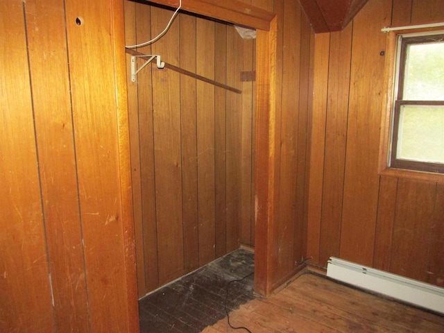 N4078 County Road A, Oxford, WI 53952 - detailed view of baseboard heating, wooden walls, and wood finished floors