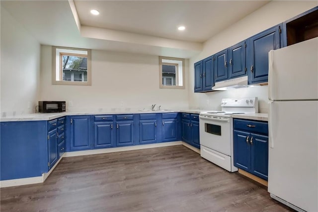324 Douglas St, Chetek, WI 54728 - kitchen featuring white appliances, under cabinet range hood, blue cabinets, a sink, and dark wood-type flooring