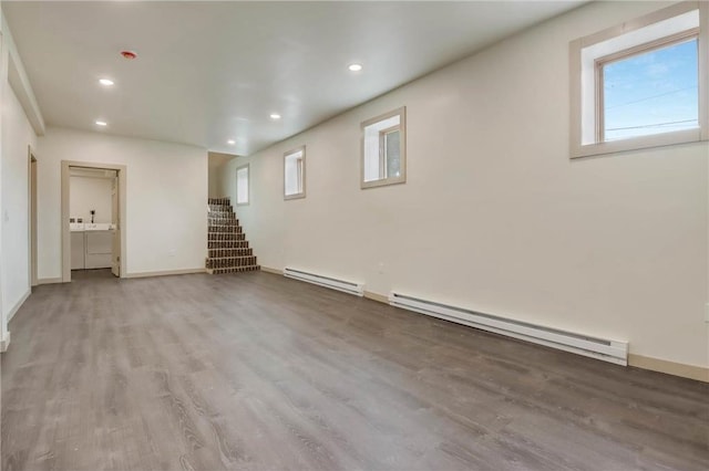 324 Douglas St, Chetek, WI 54728 - basement with a baseboard heating unit, wood finished floors, stairs, recessed lighting, and baseboards